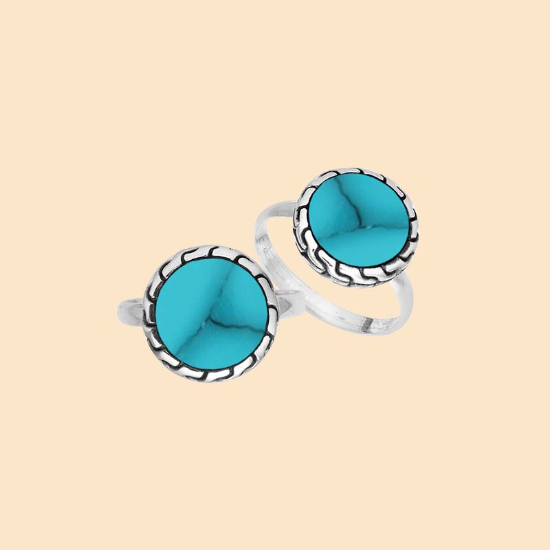 Vibrant sterling silver ring showcasing a round Turquoise Shell centerpiece surrounded by sculpted oxidized silver accents and a smoothly polished band.