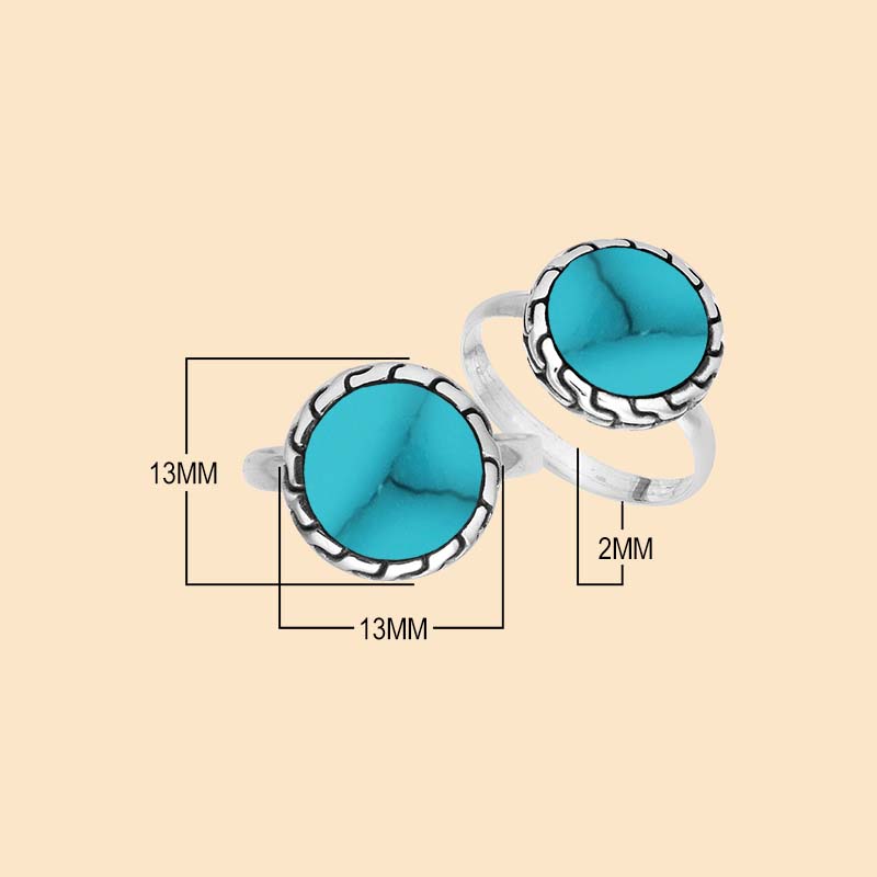 Vibrant sterling silver ring showcasing a round Turquoise Shell centerpiece surrounded by sculpted oxidized silver accents and a smoothly polished band.