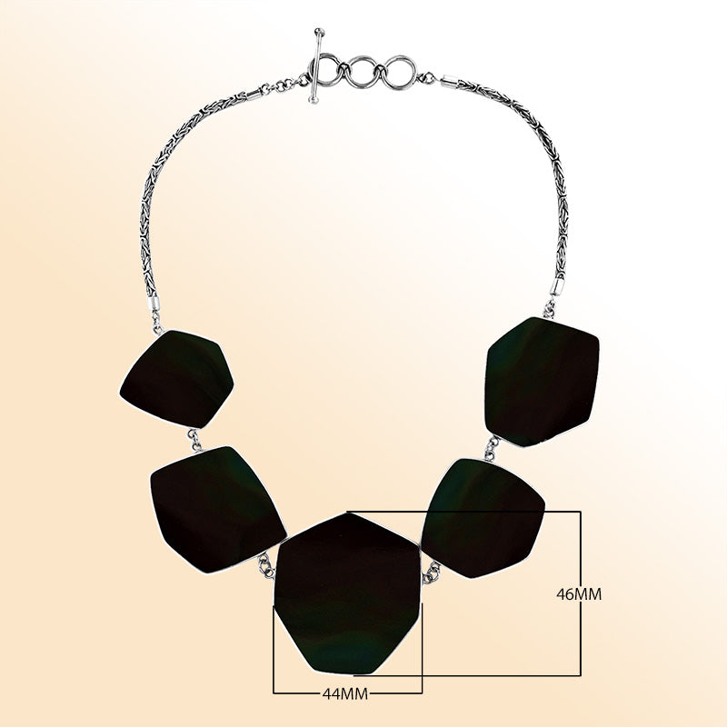 Handcrafted silver necklace with hexagon black shell links in artisan statement design.