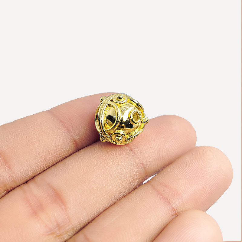 18K gold overlay Bali bead with ornate handcrafted detailing and radiant artisan finish for jewelry designs.