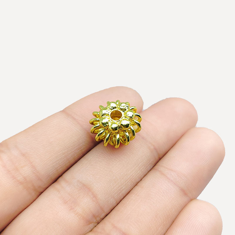 Handcrafted 18K gold overlay floral bead with copper core, artisan-made in India.