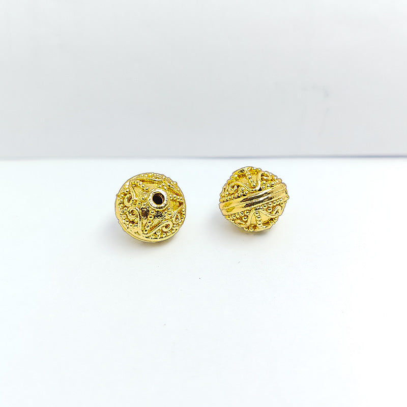 India-made 18K gold overlay copper filigree bead with polished textured design for jewelry.