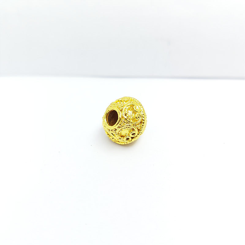 Handmade 18K gold overlay filigree copper bead with ornate scrollwork crafted in India.