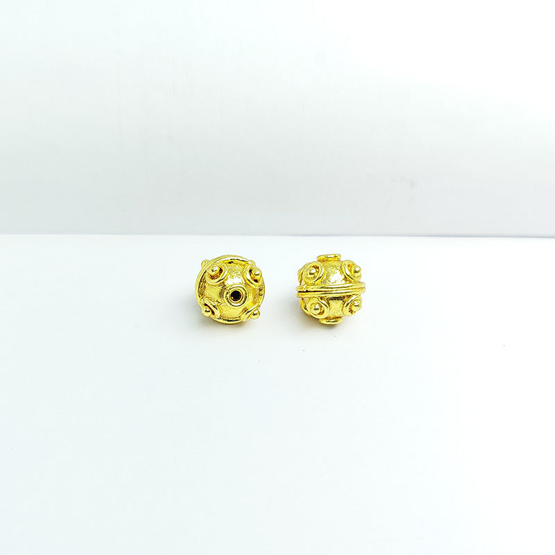 Handcrafted 18K gold overlay round copper bead from India with raised ornamental dot designs for jewelry making.