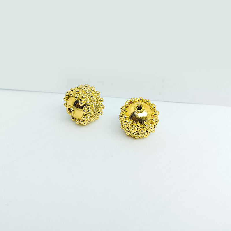Handcrafted 18K gold overlay copper bead with raised granulated texture from India for jewelry making.