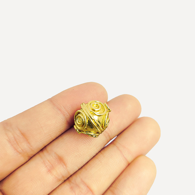 Handcrafted 18K gold overlay copper bead with swirl engravings from India for jewelry making.