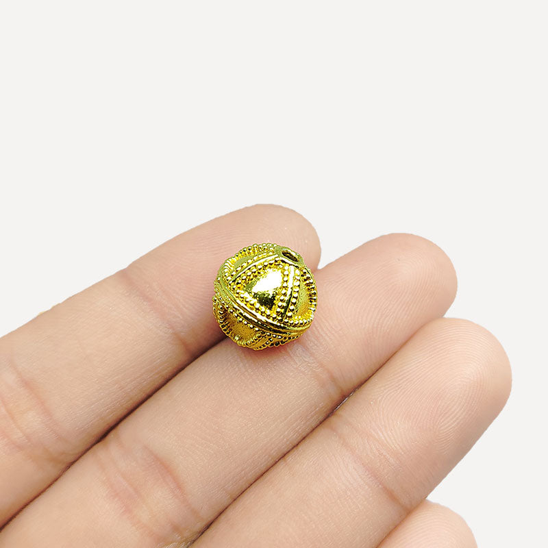 Handcrafted 18K gold overlay copper bead with cross-pattern granulation from India for jewelry making.