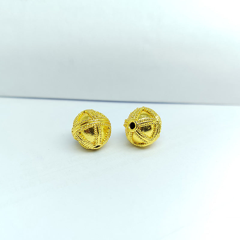 Handcrafted 18K gold overlay copper bead with cross-pattern granulation from India for jewelry making.