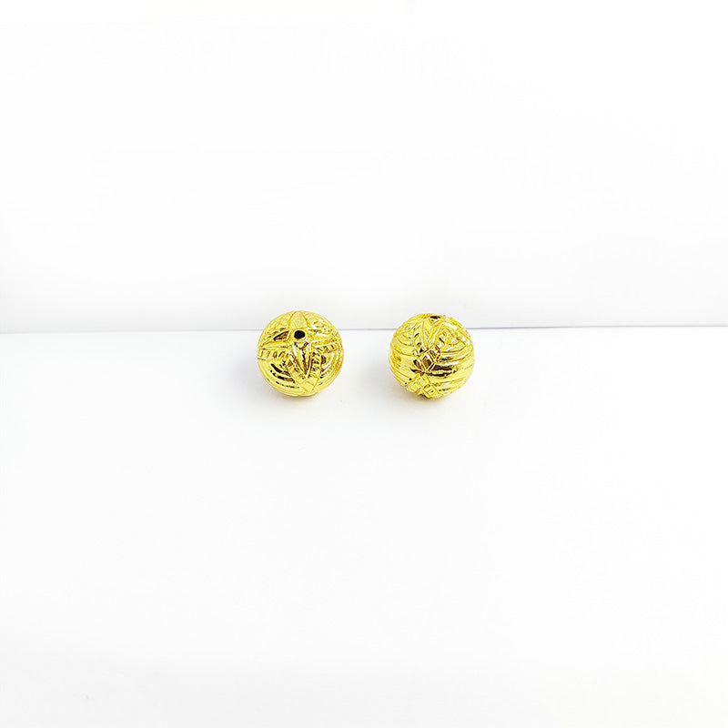 Handcrafted 18K gold overlay copper bead with engraved floral star design from India for jewelry making.