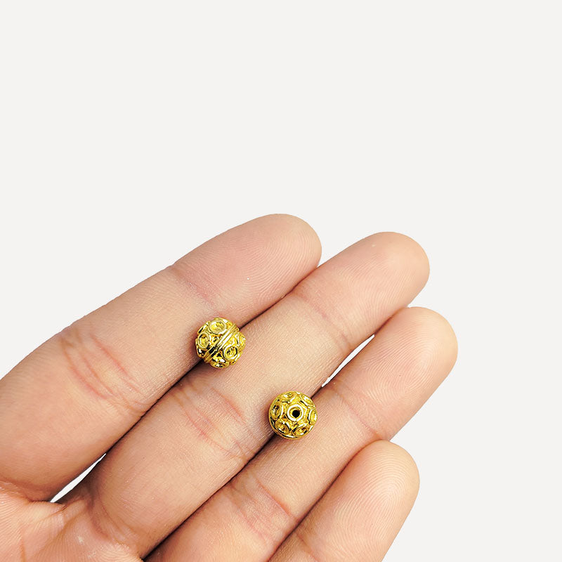 Handcrafted 18K gold overlay copper bead with embossed circular motifs from India for jewelry making.