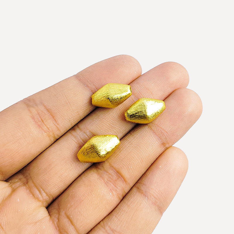 Handcrafted elongated hexa copper bead with 18K gold overlay and brushed finish, made in India.