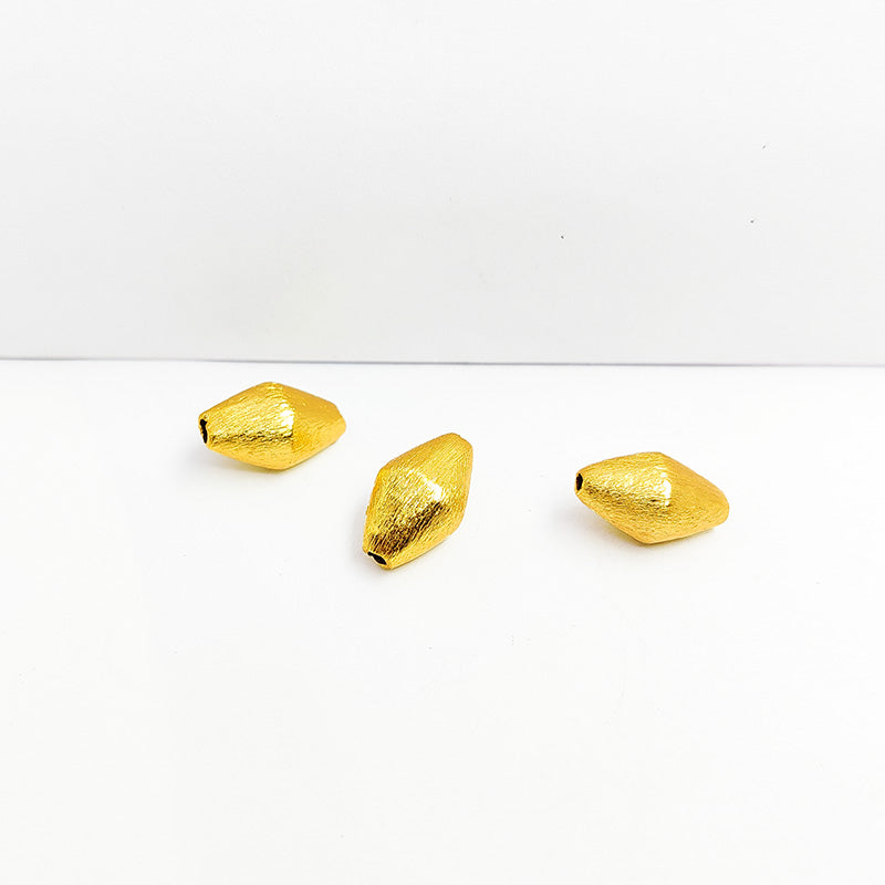Handcrafted elongated hexa copper bead with 18K gold overlay and brushed finish, made in India.