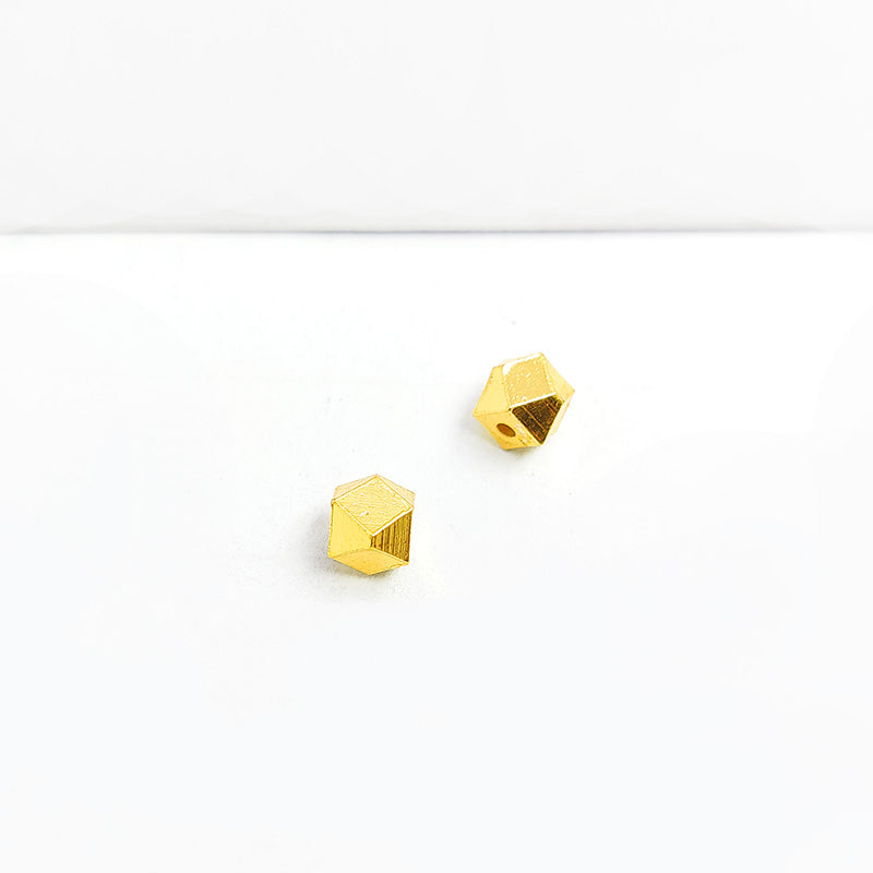 Handcrafted faceted geometric cube bead made of copper with 18K gold overlay, crafted in India.