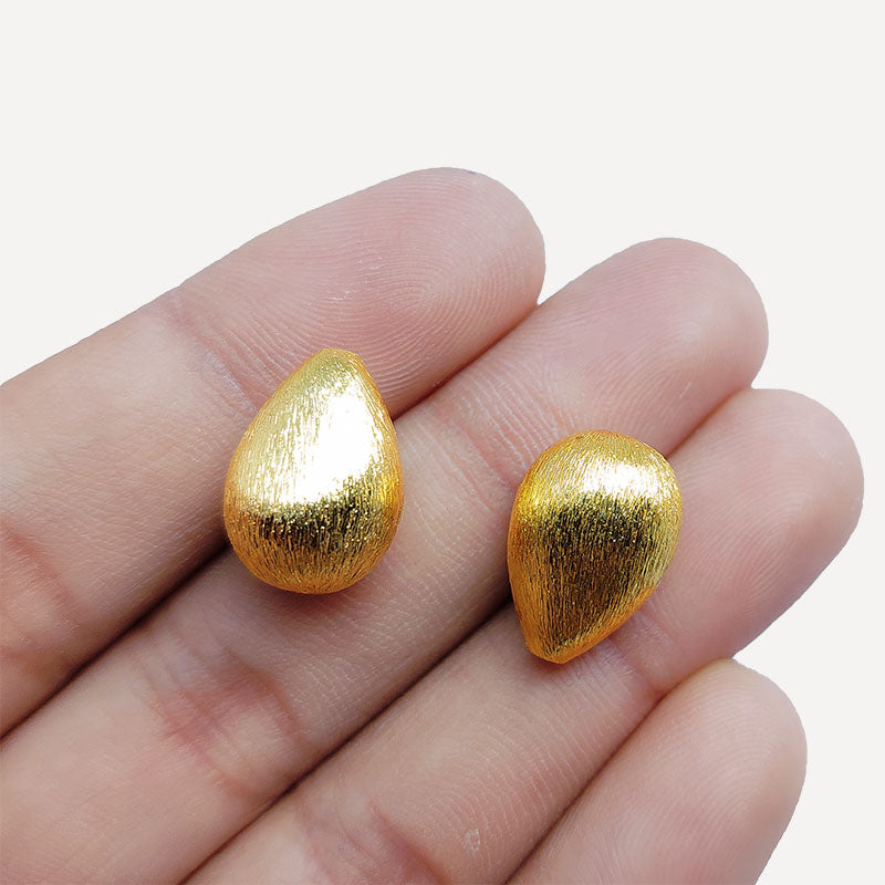 Handcrafted teardrop-shaped bead with 18K gold overlay over copper, made in India for jewelry making.