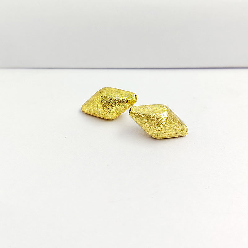 Handcrafted diamond-shaped bead with 18K gold overlay over copper, ideal for DIY jewelry making.