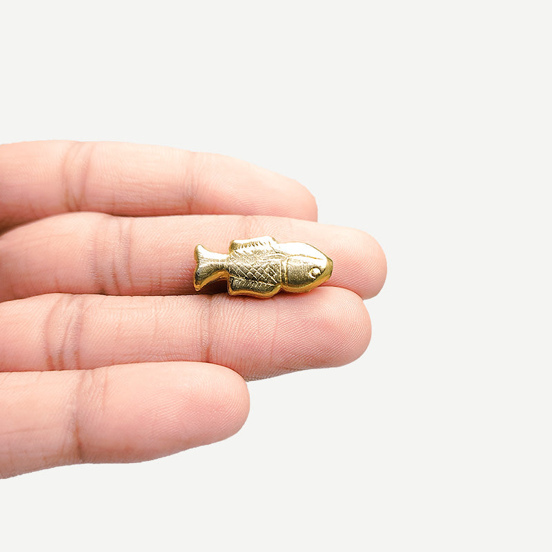 Handcrafted fish-shaped bead with 18K gold overlay made in India.