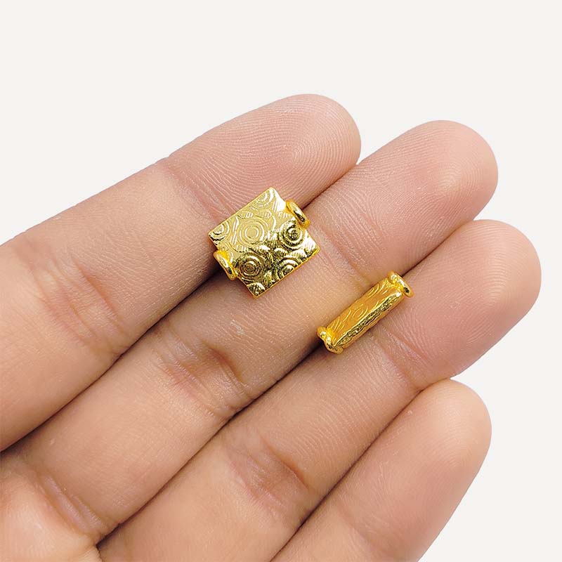 Elegant handcrafted rectangular bead made from 18K Gold Overlay Over Copper in India with engraved circular and geometric detailing.
