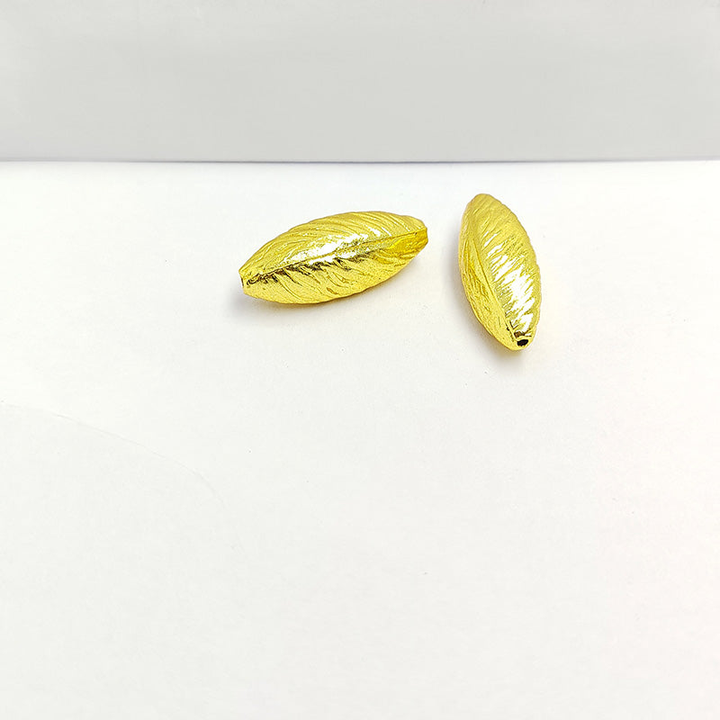Elegant handcrafted twisted marquise bead made from 18K Gold Overlay Over Copper in India with polished gold finish.