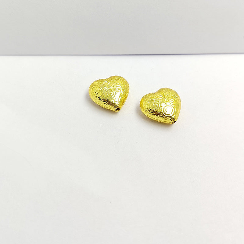 Elegant handcrafted heart-shaped bead made from 18K Gold Overlay Over Copper in India with engraved circular detailing.