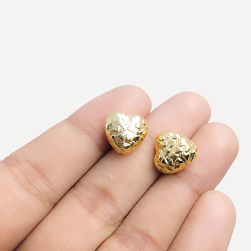 Elegant handcrafted heart-shaped bead made from 18K Gold Overlay Over Copper in India with engraved circular detailing.