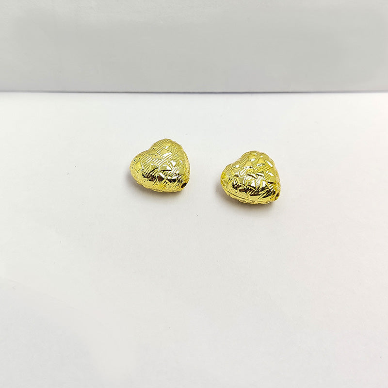 Elegant handcrafted heart-shaped bead made from 18K Gold Overlay Over Copper in India with engraved circular detailing.