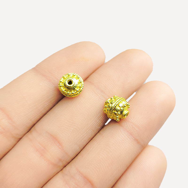 Ornate dotted round jewelry bead with 18K gold overlay over copper handcrafted in India