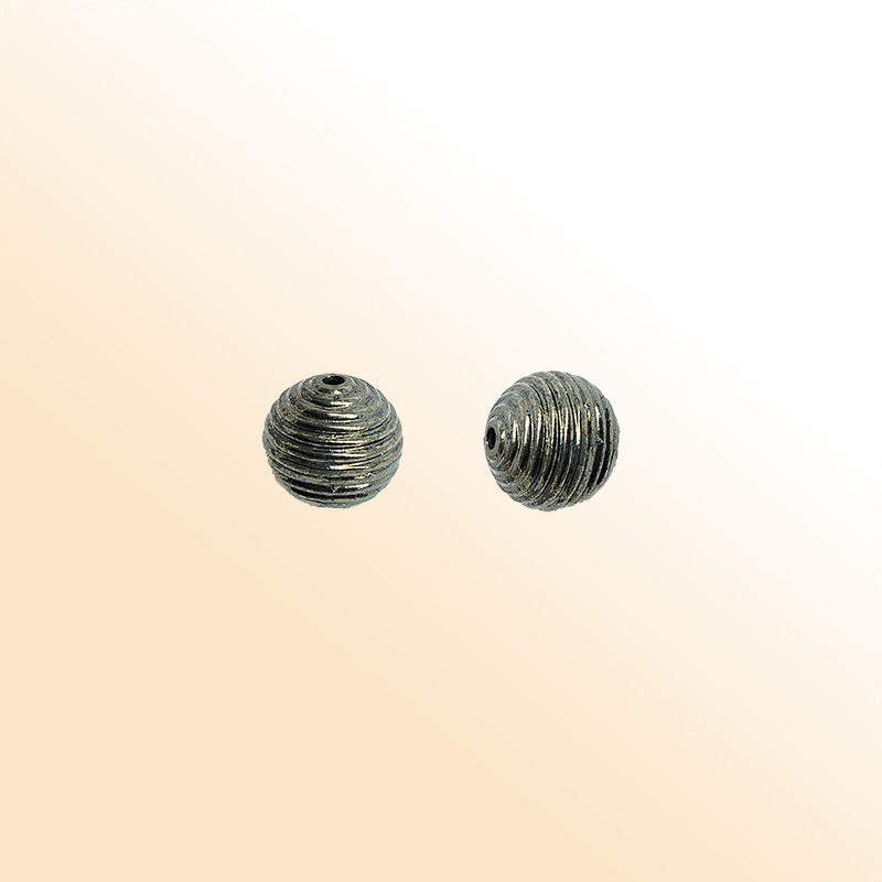 Handcrafted black rhodium overlay copper ribbed round charm from India with textured finish
