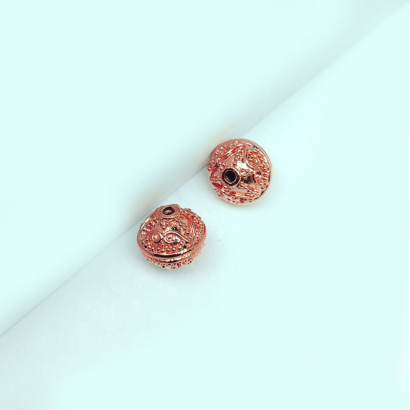 Ornate rose gold overlay copper scroll bead handcrafted in India for jewelry designs