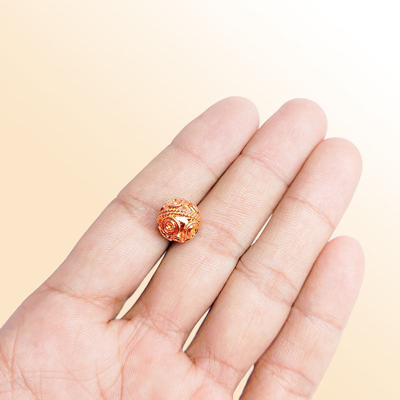 Rose gold spiral copper bead handcrafted in India with raised detailing and polished finish