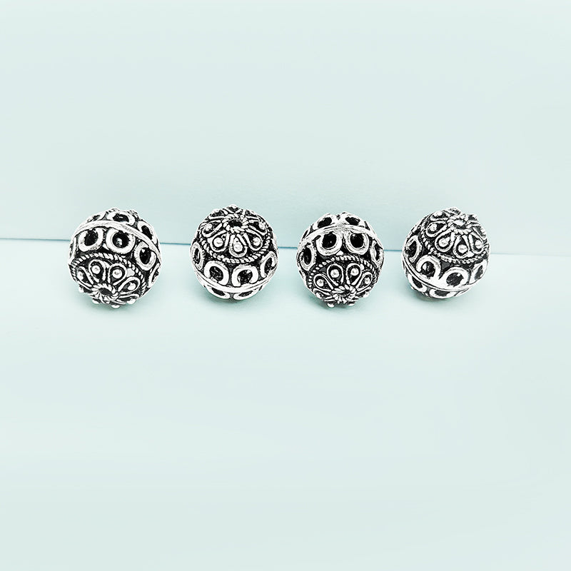 Silver ornate hollow copper bead handcrafted in India with openwork design and antique finish