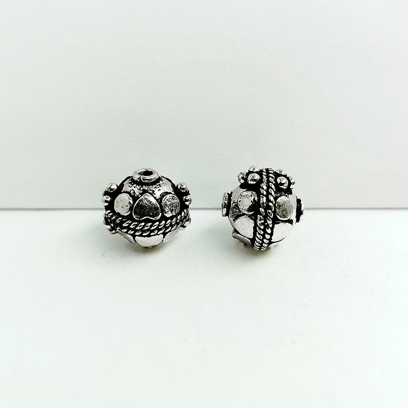 Handcrafted silver overlay round bead from India with oxidized finish and faceted motif design for retail jewelry making