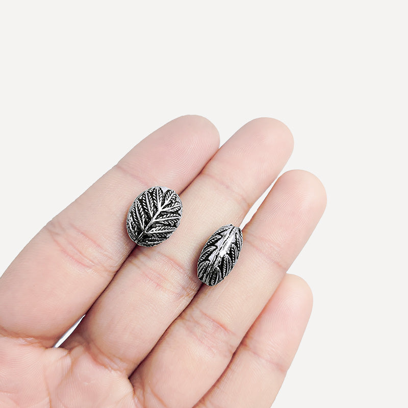 Handcrafted silver overlay oval bead from India with oxidized finish and leaf carved design for retail jewelry making