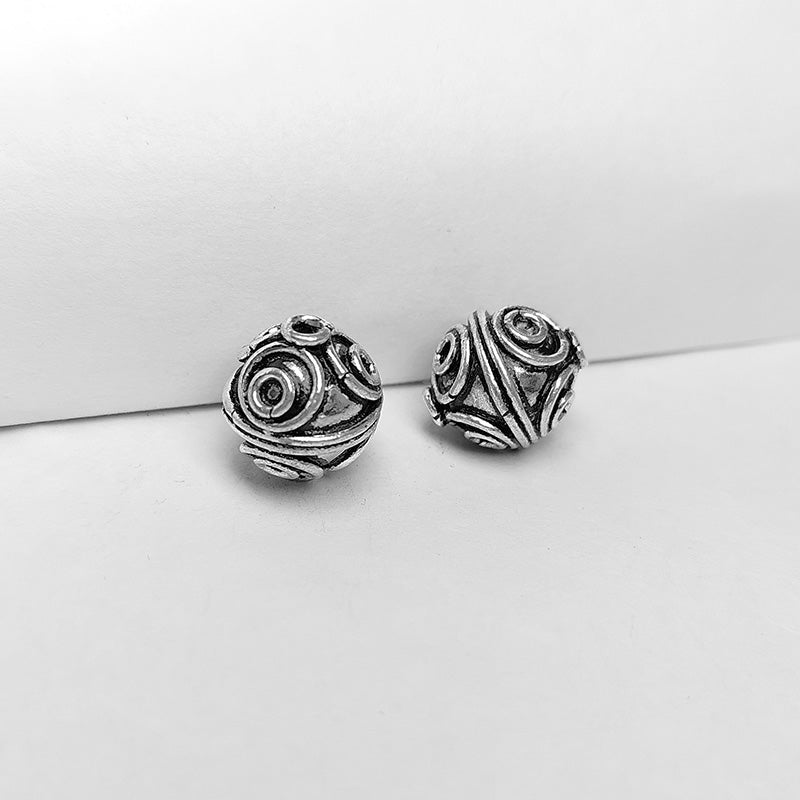 Silver overlay over copper handcrafted circular motif bead from India with antique finish jewelry spacer