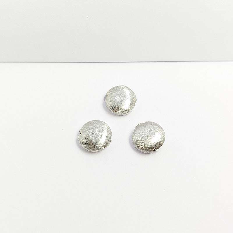 Modern silver and copper round decorative accent handcrafted in India with textured silver finish