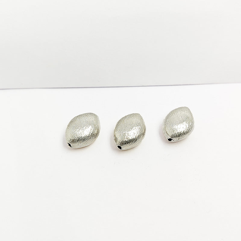 Artisan silver and copper oval shaped decor accent handcrafted in India with textured silver finish