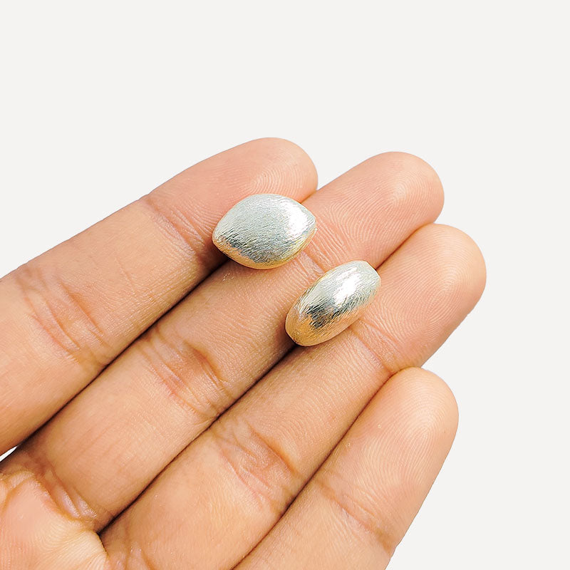 Artisan silver and copper oval shaped decor accent handcrafted in India with textured silver finish
