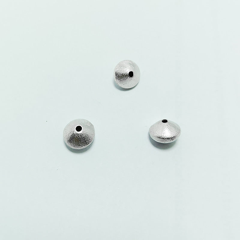 Artistic silver and copper round disc decor accent handcrafted in India with textured silver finish