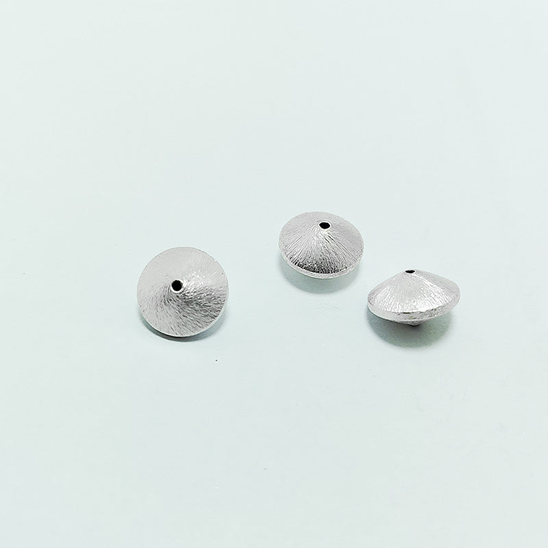 Artistic silver and copper round disc decor accent handcrafted in India with textured silver finish