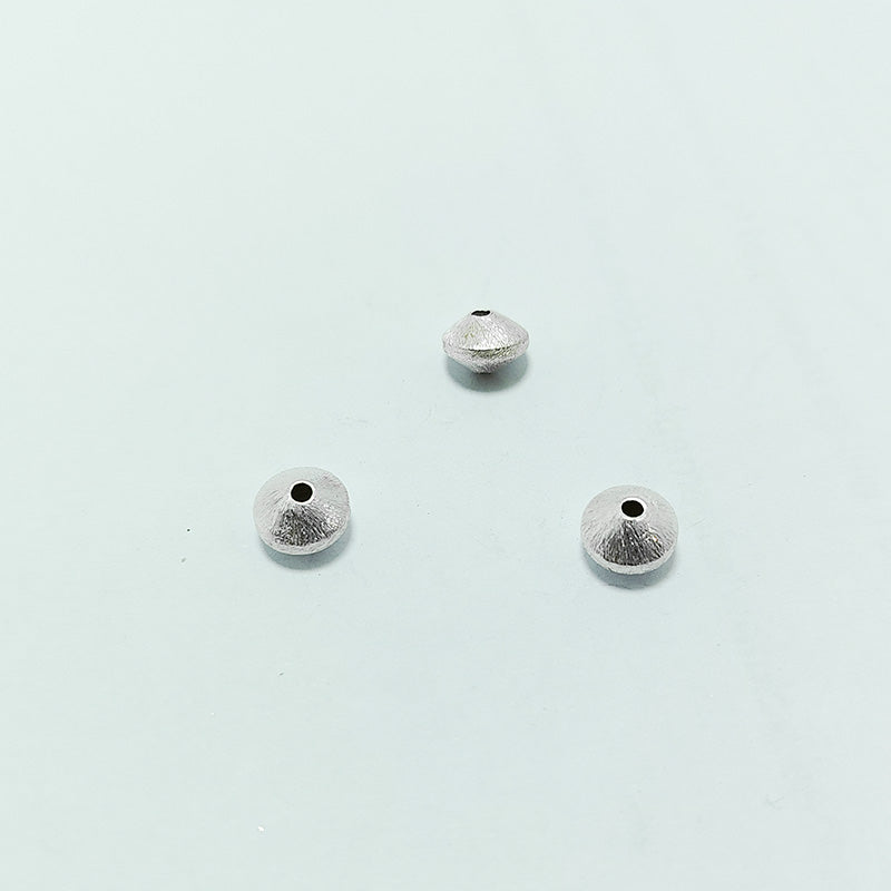 Artistic silver and copper round disc decor accent handcrafted in India with textured silver finish