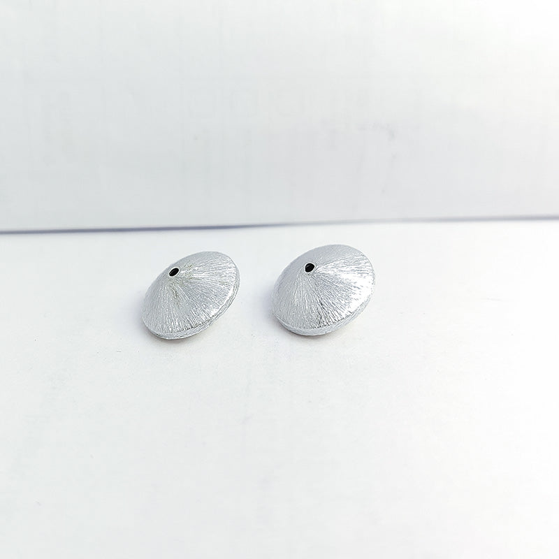 Artistic silver and copper round disc decor accent handcrafted in India with textured silver finish