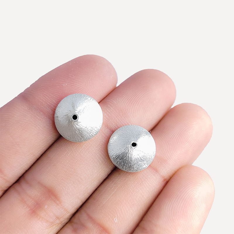 Artistic silver and copper round disc decor accent handcrafted in India with textured silver finish