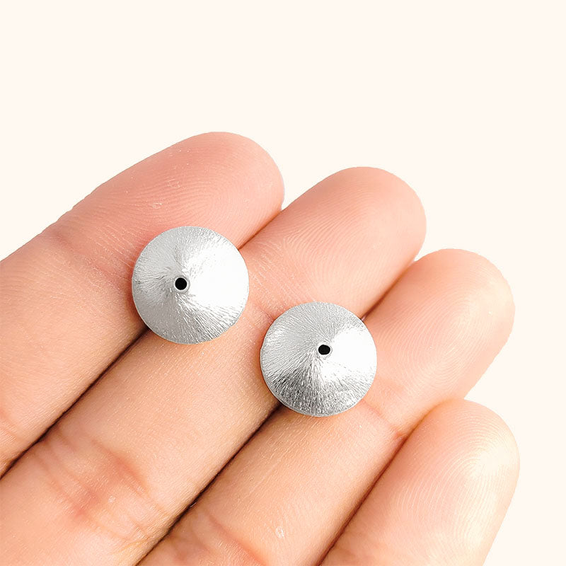 Artistic silver and copper round disc decor accent handcrafted in India with textured silver finish