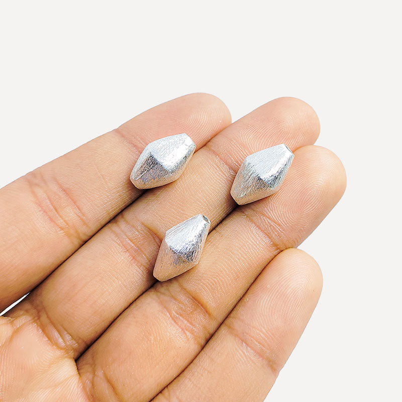 Sculptural silver and copper faceted decor accent handcrafted in India with textured silver finish