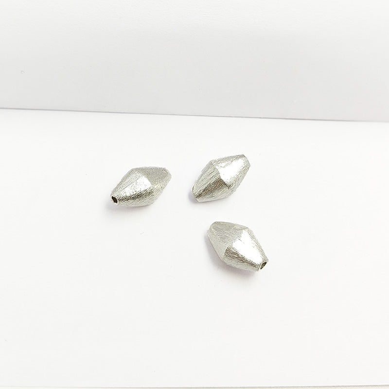 Sculptural silver and copper faceted decor accent handcrafted in India with textured silver finish