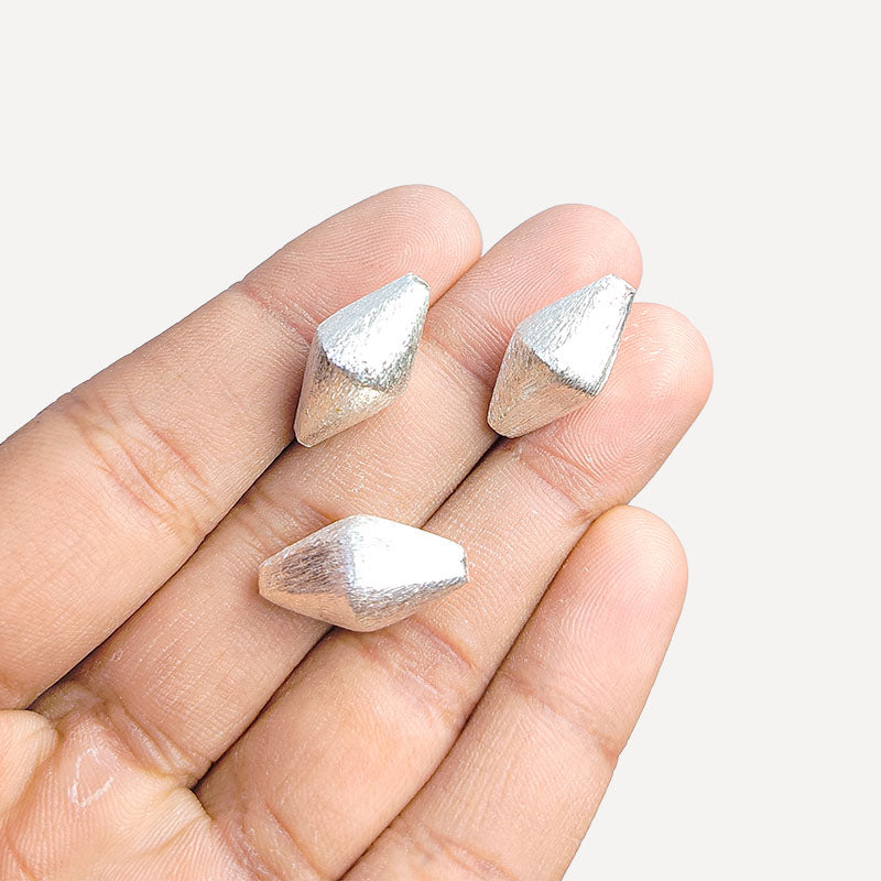 Sculptural silver and copper diamond shaped decor accent handcrafted in India with textured silver finish