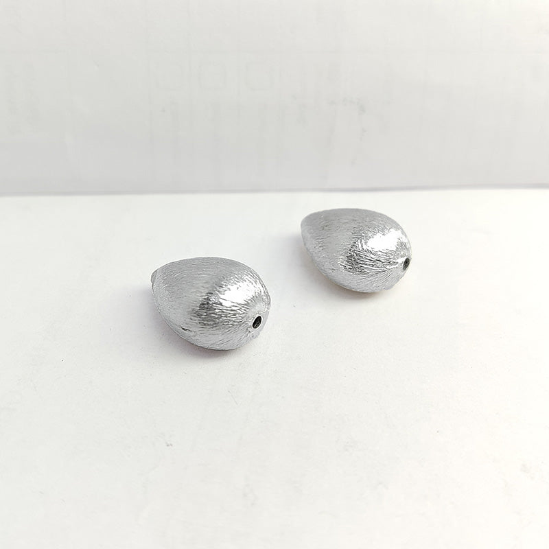 Elegant silver and copper pear shaped decor accent handcrafted in India with textured silver finish