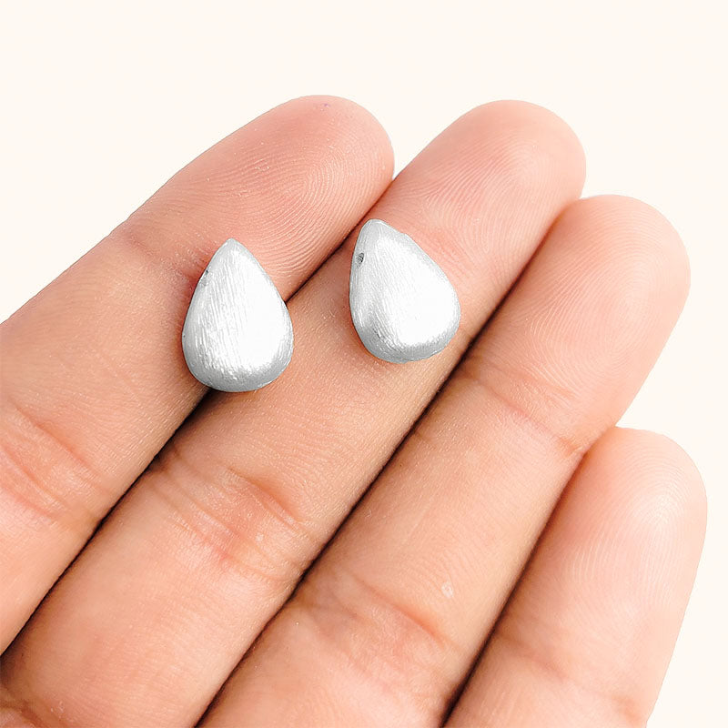 Delicate silver and copper teardrop bead accent handcrafted in India with textured silver finish