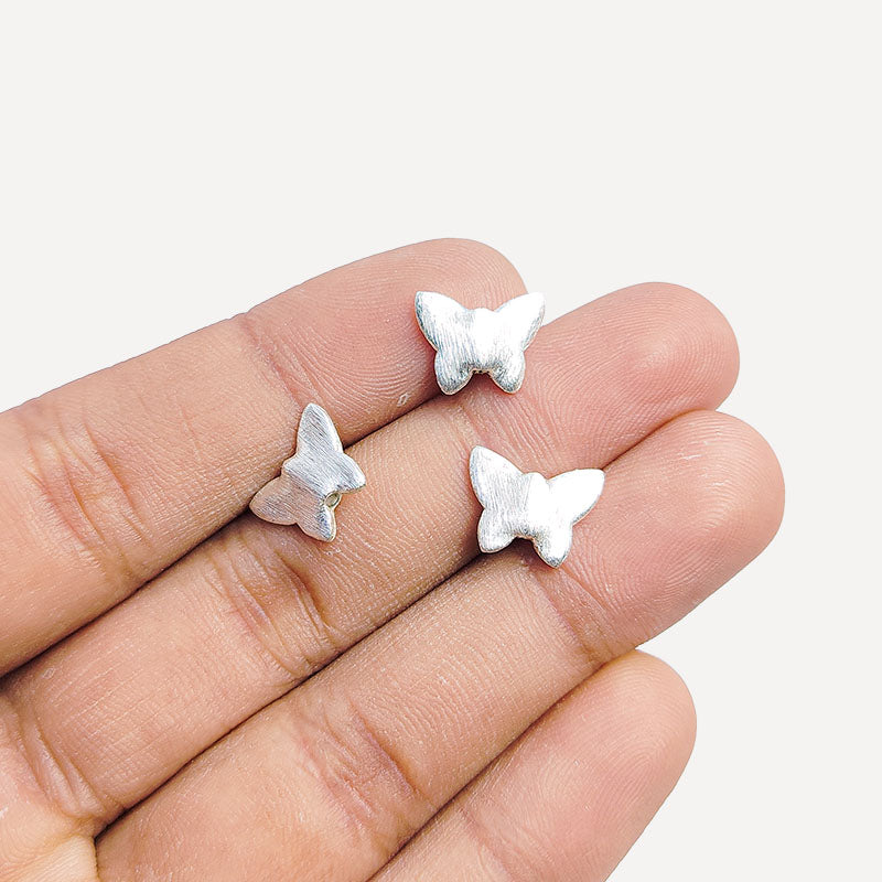 Charming silver and copper butterfly shaped decor bead handcrafted in India with textured silver finish