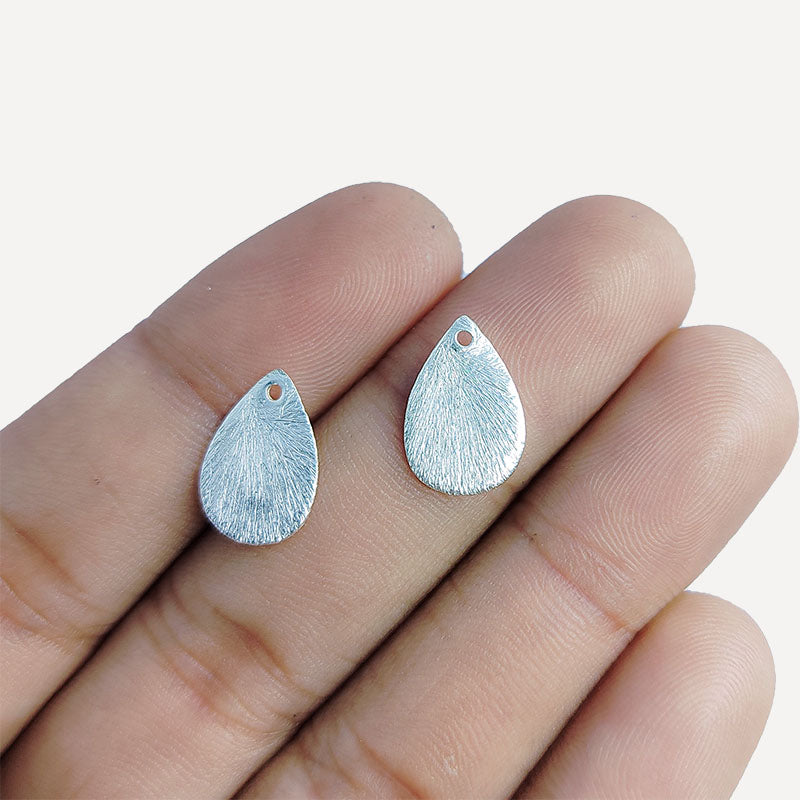 Decorative silver overlay copper textured teardrop charm handcrafted in India with top hole for jewelry making