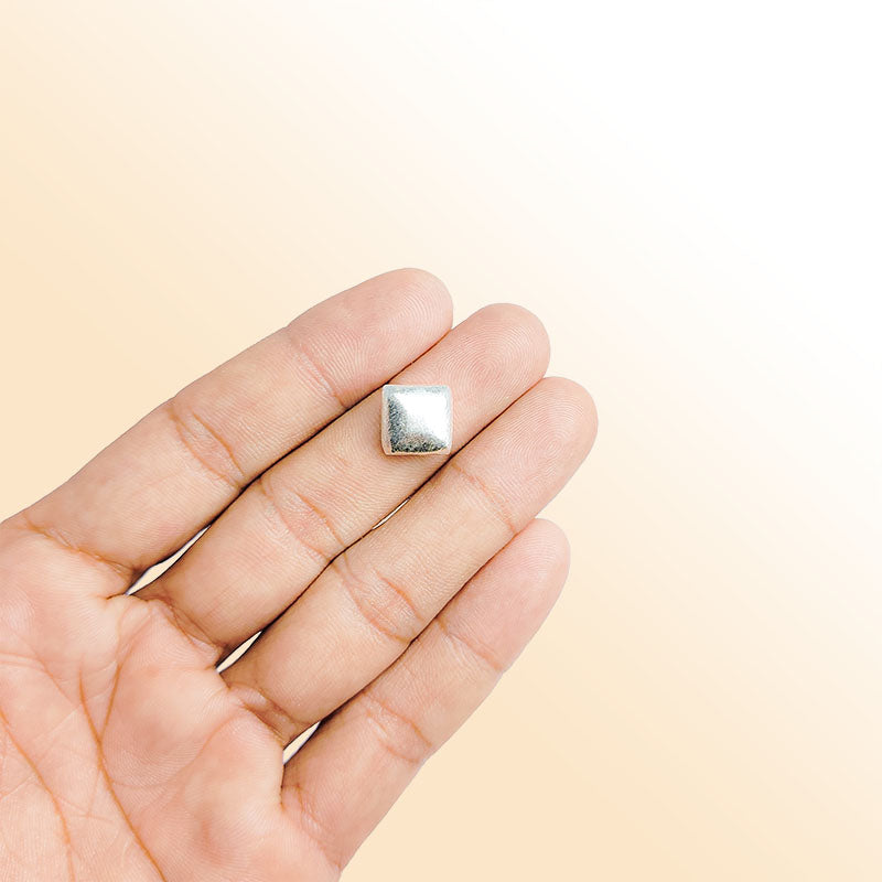 Modern silver geometric bead with textured finish, handcrafted in India using silver overlay over copper.